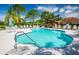 Community pool featuring a shallow end, lounge chairs, and safety equipment for residents' enjoyment at 7747 33Rd E St, Sarasota, FL 34243