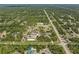Vast aerial perspective showcasing verdant landscape with multiple structures and a well-maintained road network at 8146 Tropicaire Blvd, North Port, FL 34291