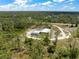 Captivating aerial view showcasing the home and its expansive wooded surroundings at 8146 Tropicaire Blvd, North Port, FL 34291