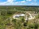 Captivating aerial view showcasing the home and its expansive wooded surroundings at 8146 Tropicaire Blvd, North Port, FL 34291