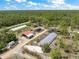 Comprehensive aerial view features farm buildings and cultivated areas, presenting a blend of agriculture and nature at 8146 Tropicaire Blvd, North Port, FL 34291