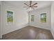 A bright bedroom featuring hard wood floors and three large windows at 8146 Tropicaire Blvd, North Port, FL 34291