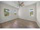 Bright bedroom with three windows and wood floors, perfect for any decor at 8146 Tropicaire Blvd, North Port, FL 34291