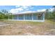 Charming blue house with a spacious porch, perfect for relaxing and enjoying the outdoors at 8146 Tropicaire Blvd, North Port, FL 34291