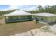 Exterior of building with a metal roof and green paint on land at 8146 Tropicaire Blvd, North Port, FL 34291