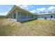 Inviting exterior of a blue home featuring a long porch, ideal for outdoor living and entertaining at 8146 Tropicaire Blvd, North Port, FL 34291