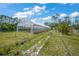 Well-maintained greenhouse on a lush property, ideal for agricultural or horticultural purposes at 8146 Tropicaire Blvd, North Port, FL 34291