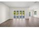A naturally lit living room featuring wood floors and sliding doors to an outdoor space at 8146 Tropicaire Blvd, North Port, FL 34291