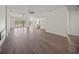 Open-concept living area with wood-look floors and kitchen in the background at 8146 Tropicaire Blvd, North Port, FL 34291