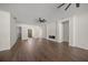 Spacious living room with tile floors, ceiling fans, and fireplace at 8146 Tropicaire Blvd, North Port, FL 34291