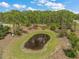 Picturesque pond providing a serene natural amenity within a lush, wooded setting at 8146 Tropicaire Blvd, North Port, FL 34291