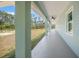 View of the long, covered porch with view of the yard at 8146 Tropicaire Blvd, North Port, FL 34291