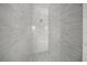 Contemporary shower with modern tiling and pebble stone flooring at 8146 Tropicaire Blvd, North Port, FL 34291