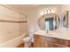 A bathroom featuring a tile shower, toilet, and wooden vanity with an oval mirror at 1030 Villagio Cir # 103, Sarasota, FL 34237