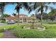 This community features a beautiful fountain, lush landscaping, and a community building at 1030 Villagio Cir # 103, Sarasota, FL 34237