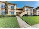 Two-story exterior with well-manicured lawn and inviting entryway, great for curb appeal at 1030 Villagio Cir # 103, Sarasota, FL 34237