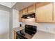 Close-up of the kitchen range, backsplash, and cabinets at 1030 Villagio Cir # 103, Sarasota, FL 34237