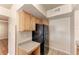 A well-organized kitchen with a black refrigerator, lots of cabinet space, and durable countertops at 1030 Villagio Cir # 103, Sarasota, FL 34237