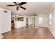Open living room with wood floors and ample space, leading to a kitchen area at 1030 Villagio Cir # 103, Sarasota, FL 34237