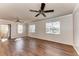 Bright living room featuring hardwood floors, neutral paint, and dual ceiling fans at 1030 Villagio Cir # 103, Sarasota, FL 34237