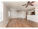 Spacious living room with wood floors, neutral walls, and bright, natural lighting at 1030 Villagio Cir # 103, Sarasota, FL 34237