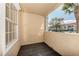 This outdoor patio area has a black tile floor and a stucco privacy wall for a relaxing experience at 1030 Villagio Cir # 103, Sarasota, FL 34237