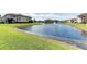 This scenic pond features a fountain, well-manicured lawn, and a building nearby at 1030 Villagio Cir # 103, Sarasota, FL 34237