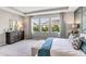 Bright bedroom featuring natural light, tray ceiling and accent wall with geometric design at 10721 Tippecanoe Pl, Parrish, FL 34219