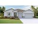 Charming single-story home with a gray exterior, well-manicured lawn and a two car garage at 10721 Tippecanoe Pl, Parrish, FL 34219