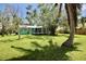Expansive backyard with a wood deck and mature trees offering shade and privacy at 12107 45Th W Ave, Cortez, FL 34215