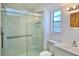 Modern bathroom featuring glass shower, white marble tiles, and neutral fixtures at 12107 45Th W Ave, Cortez, FL 34215