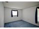 Minimalist bedroom with blue carpet and neutral walls, ready for personal touches at 12107 45Th W Ave, Cortez, FL 34215