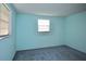 Bright bedroom featuring blue walls, neutral trim, and plush carpet for a relaxing retreat at 12107 45Th W Ave, Cortez, FL 34215