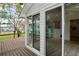 Outdoor porch featuring a wooden deck and sliding door access to the home at 12107 45Th W Ave, Cortez, FL 34215