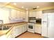 The kitchen features white cabinets and laminate countertops at 12107 45Th W Ave, Cortez, FL 34215