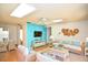 Cozy living room with white wicker furniture and bright blue accent wall at 12107 45Th W Ave, Cortez, FL 34215