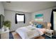 Cozy main bedroom with a white wicker bed frame, blue accents, and natural light at 12107 45Th W Ave, Cortez, FL 34215