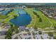 Expansive aerial view showcasing a golf course with multiple water features, mature trees, and surrounding residential areas at 1245 Millbrook Cir, Bradenton, FL 34212