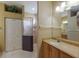 Well-lit bathroom with a glass shower, neutral vanity, and plenty of storage at 1245 Millbrook Cir, Bradenton, FL 34212