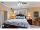 Comfortable main bedroom with a decorative bed frame, ceiling fan, and natural lighting at 1245 Millbrook Cir, Bradenton, FL 34212