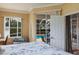 Bright bedroom with a seating area and sliding doors leading to the screened pool at 1245 Millbrook Cir, Bradenton, FL 34212