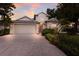 Charming two-story home with a well-maintained lawn, a neutral stucco exterior, and a two-car garage at 1245 Millbrook Cir, Bradenton, FL 34212