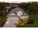 Inviting two-story home featuring a well-manicured lawn, a neutral stucco exterior, and a two-car garage at 1245 Millbrook Cir, Bradenton, FL 34212