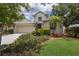 Charming two-story home featuring mature landscaping, a neutral stucco exterior, and a two-car garage at 1245 Millbrook Cir, Bradenton, FL 34212