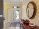 Welcoming foyer with beautiful tile floors, a decorative mirror, and a view to the front door at 1245 Millbrook Cir, Bradenton, FL 34212