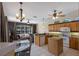 Open concept kitchen with island, stainless appliances, and adjoining seating area at 1245 Millbrook Cir, Bradenton, FL 34212