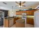 Well-lit kitchen with wood cabinets, island, and modern appliances at 1245 Millbrook Cir, Bradenton, FL 34212