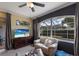 Cozy living area with a large window, TV, comfortable seating, and a ceiling fan at 1245 Millbrook Cir, Bradenton, FL 34212
