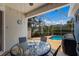 Covered patio featuring a table and chairs overlooking the screened in pool at 1245 Millbrook Cir, Bradenton, FL 34212
