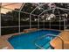 Relaxing screened pool with cool blue water and a brick trim under a sunset-colored sky at 1245 Millbrook Cir, Bradenton, FL 34212